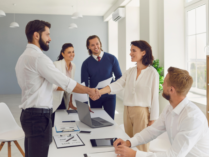 Business broker shaking hands after signing an agreement, representing trust and partnership for the best commercial insurance Ontario.
