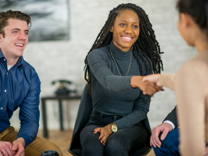 Professionals reaching a successful agreement – highlighting security and liability insurance for businesses.
